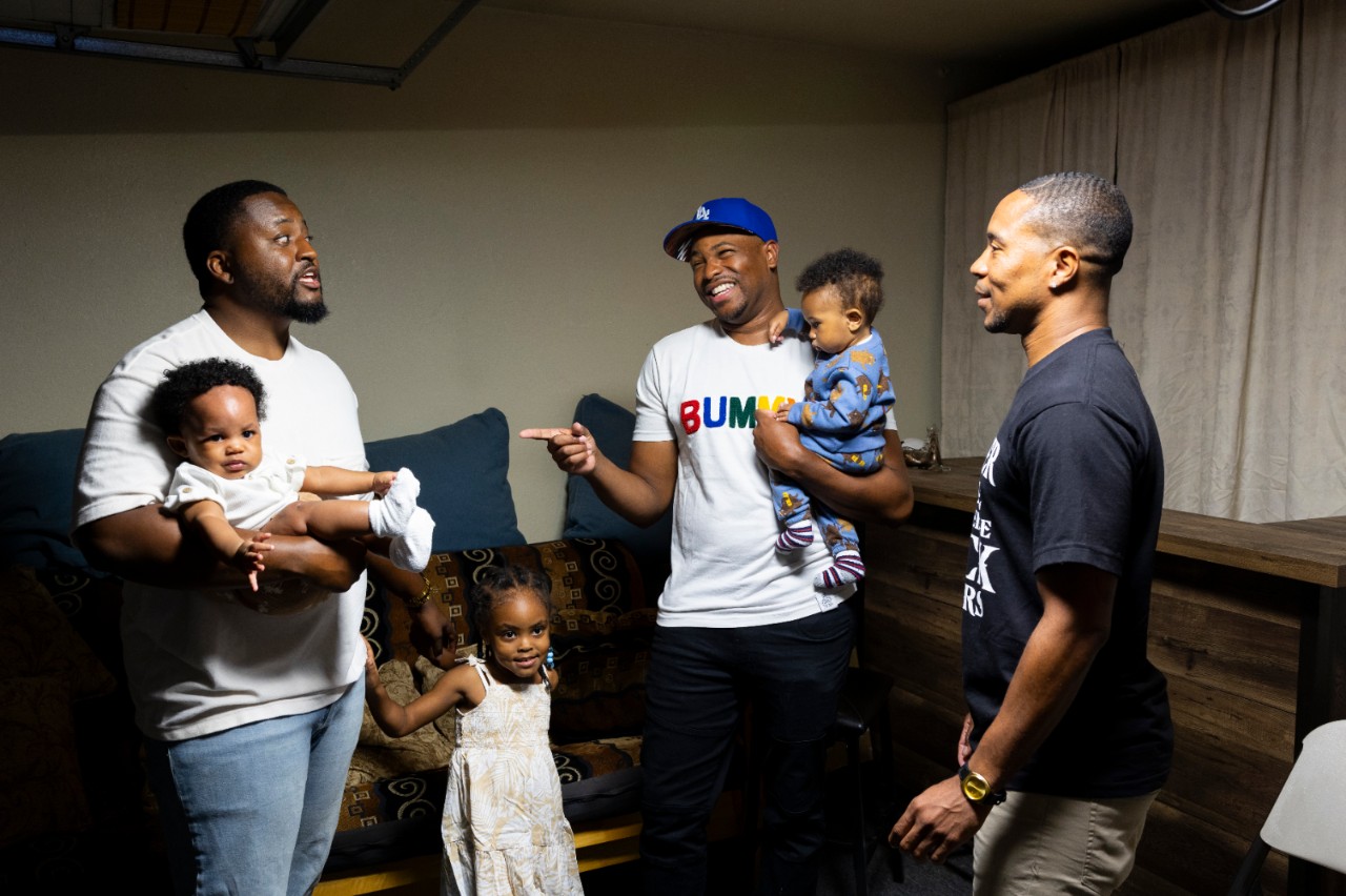 Davion Mauldin, fatherhood coordinator for AAIMM (African American Infant and Maternal Mortality Initiative), hosts a meetup for Black fathers in Compton, California on October 23, 2023. From left to right: Danny Rollins, Braylen Rollins, 5 months, Jayce Hamilton, 4, Jarritt Jamison, Carter Jamison, 8 months, and Davion Maudlin. AAIMM hosts support groups and programs to engage Black fathers and highlight them as key members of the village of support for expectant mothers.