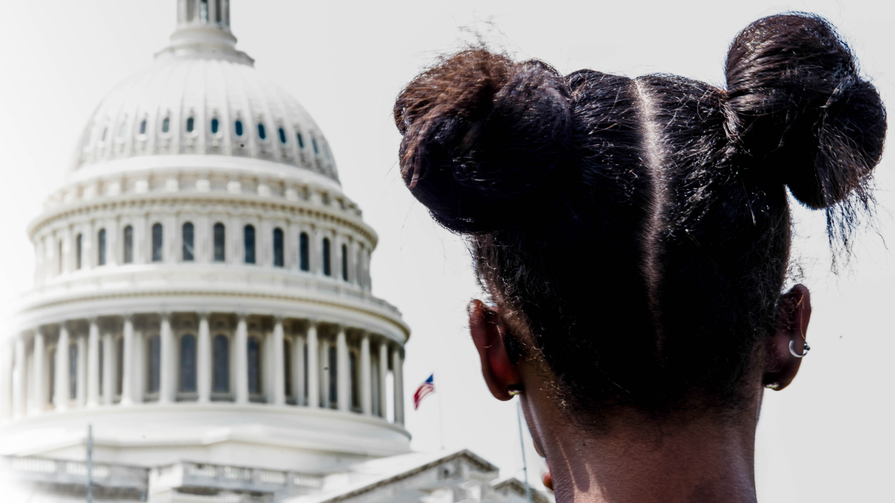 Child in forefront of Capitol building. 