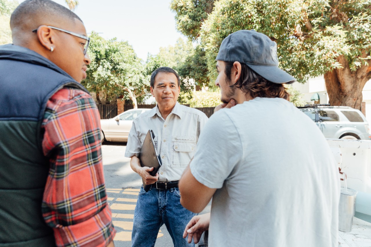 Workers on a job site talk.